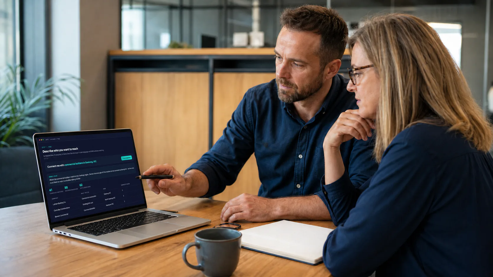 An automation consultant and business owner reviewing an implementation together